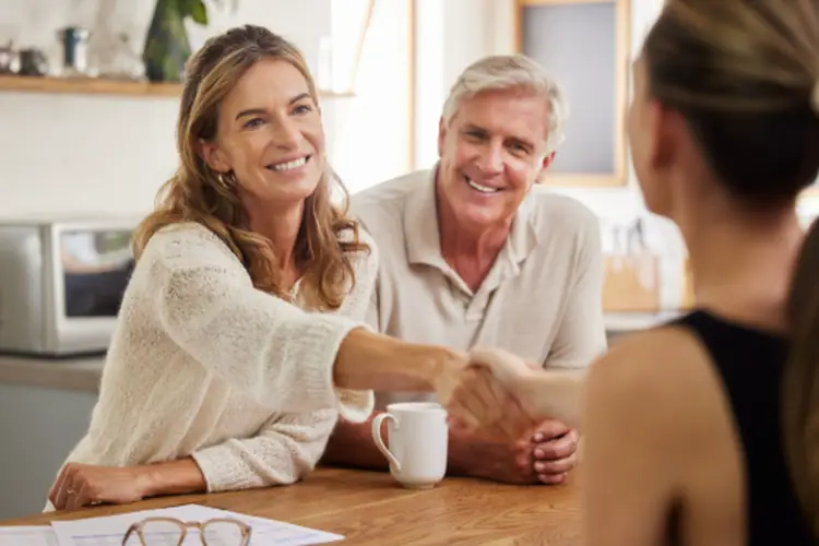 a couple on a consultation, and women shaking hands 