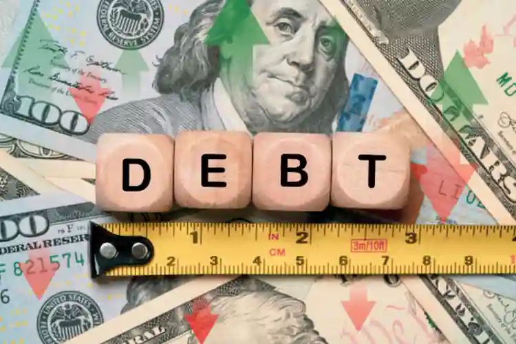 Debt wording with measure tape on a USD dollar banknote.