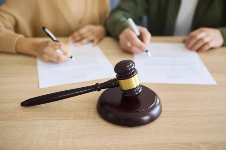 Couple signing probate document at court with a gavel.