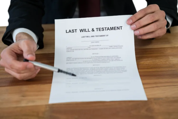 A lawyer presenting their client with a last will and testament document. 